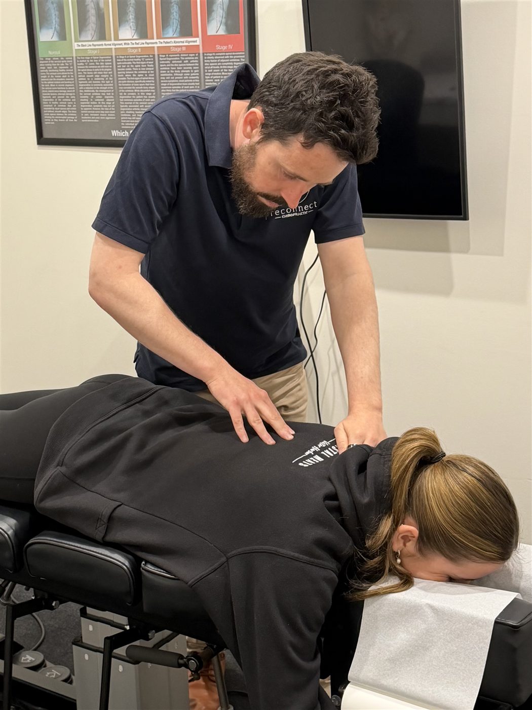 Dr Michael Harney performing a spinal examination